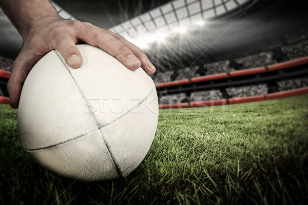 Composite image of a rugby player posing a rugby ball Stock photo © wavebreak_media