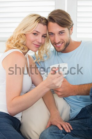 Couple in bed drinking coffee with affection Stock photo © wavebreak_media