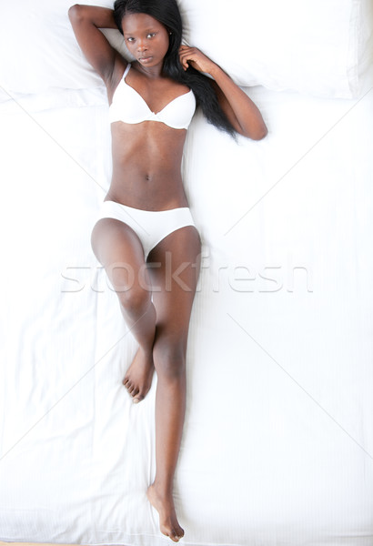 Relaxed pretty woman lying on her bed Stock photo © wavebreak_media
