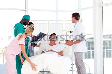 Stock photo: Doctor showing an X-ray to his patient