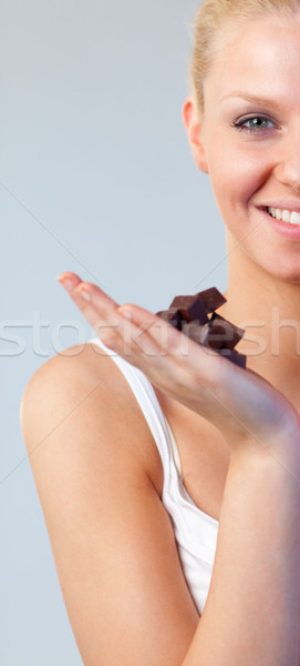 Stock photo: Close-up of an attractive woman holding chocolate focus on woman 