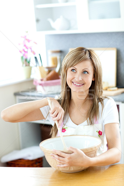 Cute woman preparing a cake in the kitchen Stock photo © wavebreak_media