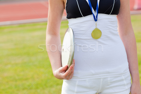 Close-up of a female athlete holding a disc preparing for throwing in a stadium Stock photo © wavebreak_media