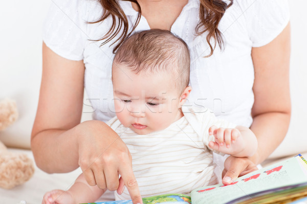 Attentive mother showing images in a book to her cute little son at home Stock photo © wavebreak_media