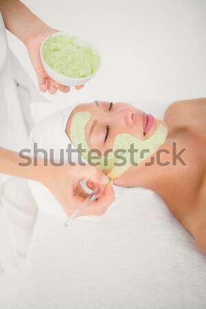 Portrait of a happy woman having massage oil versed on her back Stock photo © wavebreak_media