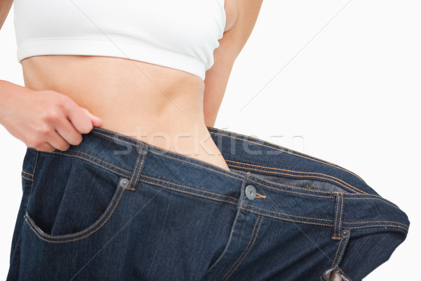 Close-up of a woman waist who lost a lot of weight against white background Stock photo © wavebreak_media