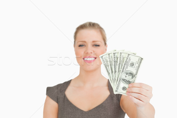 Woman showing dollars banknotes against white background Stock photo © wavebreak_media
