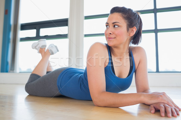 Stock photo: Woman lying on the floor smiling in fitness studio