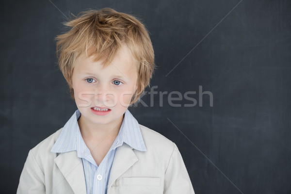 Boy dressed as teacher and stands in front of black board Stock photo © wavebreak_media