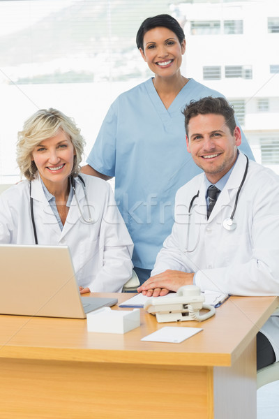 Smiling doctors with laptop at medical office Stock photo © wavebreak_media