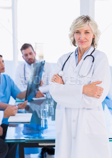 Smiling female doctor with colleagues in meeting Stock photo © wavebreak_media