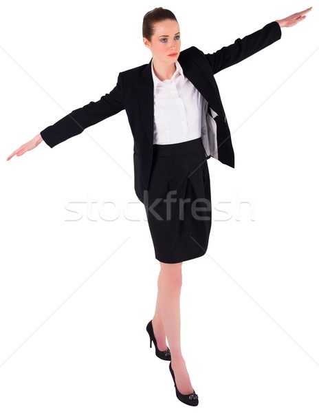 Femeie de afaceri echilibrare acţiona alb mers Imagine de stoc © wavebreak_media