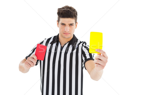 Stock photo: Stern referee showing yellow card