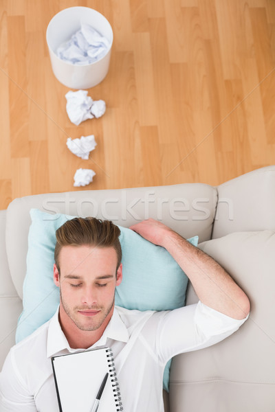 Man resting on couch with writer block Stock photo © wavebreak_media