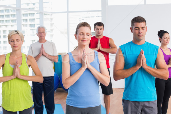 People meditating with hands joined in fitness club Stock photo © wavebreak_media