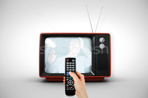 Composite image of hand holding remote control Stock photo © wavebreak_media