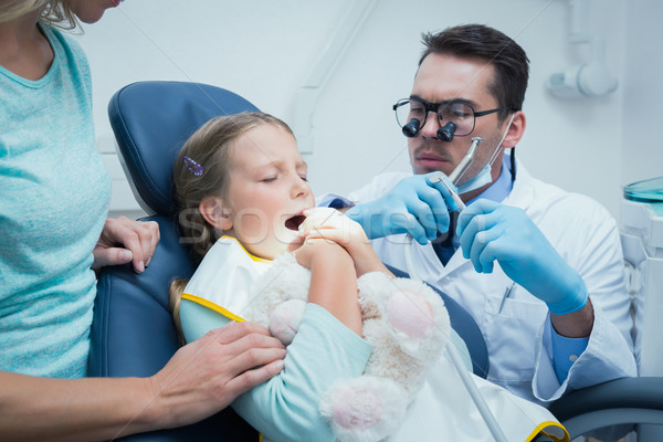 Dentist examining girls teeth with assistant Stock photo © wavebreak_media
