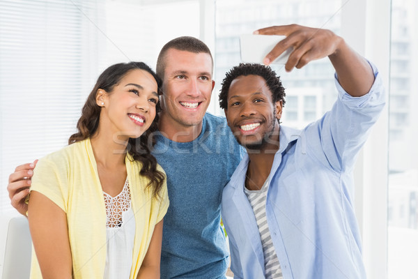 Smiling colleagues taking selfies Stock photo © wavebreak_media