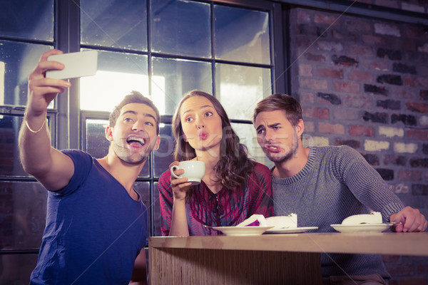 Grimacing friends taking selfies  Stock photo © wavebreak_media