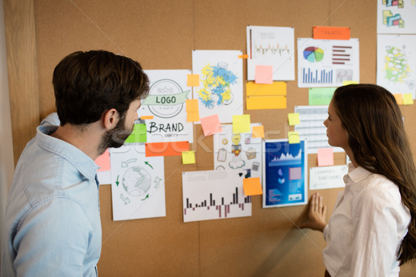 Business colleagues looking at charts on soft board Stock photo © wavebreak_media