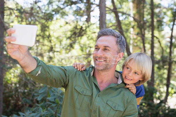 Smiling father and son taking selfie in forest Stock photo © wavebreak_media