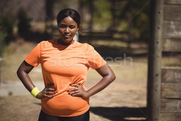 Portrait of confident woman standing with hands on hip during obstacle course Stock photo © wavebreak_media