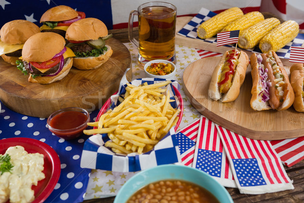 Hot dogs and burgers on wooden table with 4th july theme Stock photo © wavebreak_media
