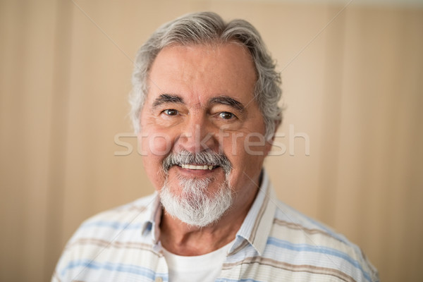 Close-up portrait of senior man against wall Stock photo © wavebreak_media