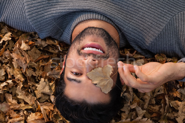 Overhead of man lying on autumn leaves Stock photo © wavebreak_media