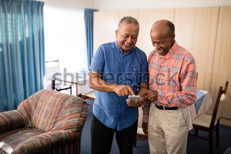 Portrait of senior man and female doctor holding hands in nursing home Stock photo © wavebreak_media