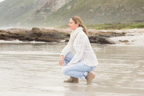 Woman crouching at the shore Stock photo © wavebreak_media