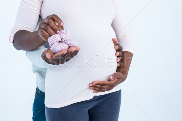 Mid section of man holding baby shoes along with wife  Stock photo © wavebreak_media