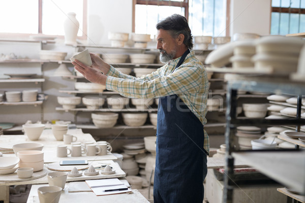 Male potter checking craft product Stock photo © wavebreak_media