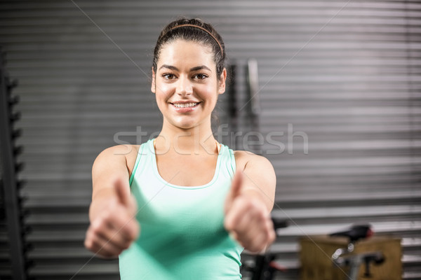 Happy athletic woman with thumbs up Stock photo © wavebreak_media