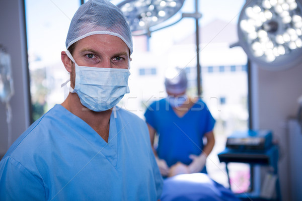 Portret masculin asistentă masca chirurgicala operatie Imagine de stoc © wavebreak_media