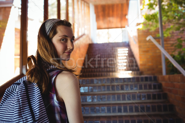 Portrait of schoolgirl to schoolbag standing near staircase Stock photo © wavebreak_media