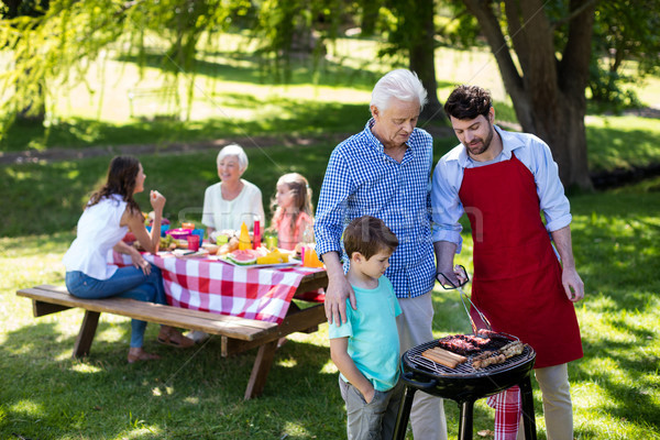 Grandfather, father and son barbequing in the park Stock photo © wavebreak_media