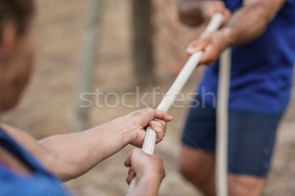 Man and woman playing tug of war during obstacle course Stock photo © wavebreak_media
