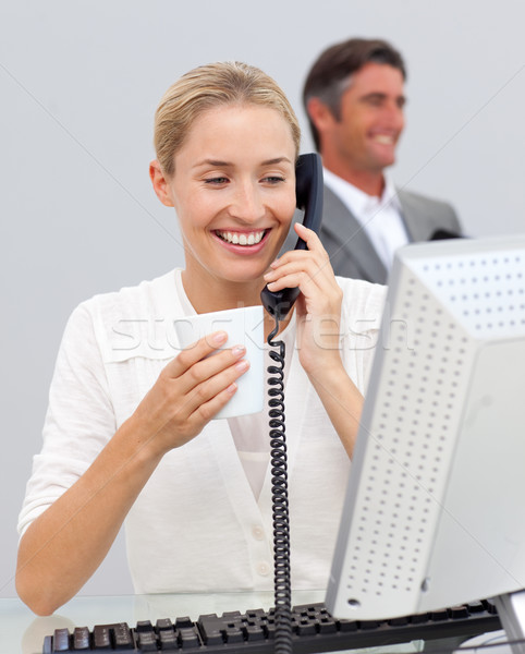 Smiling businesswoman drinking coffee and talking on phone Stock photo © wavebreak_media