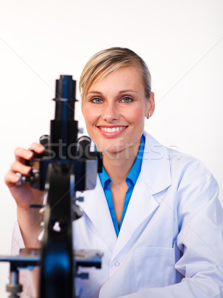 Beautiful scientist with a microscope  Stock photo © wavebreak_media
