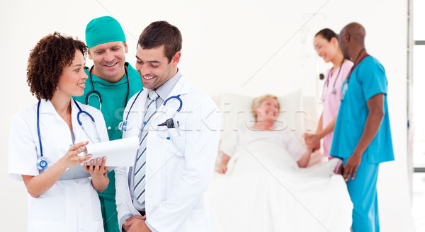 Group of international doctors with a patient in a hospital Stock photo © wavebreak_media