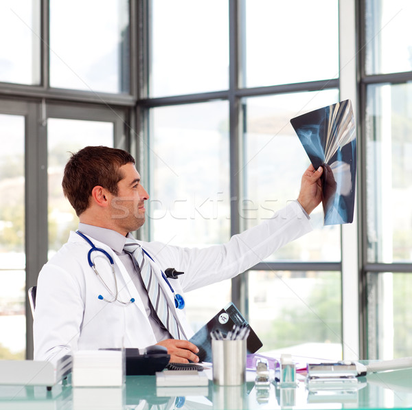 Confident doctor in his office looking at a x-ray Stock photo © wavebreak_media