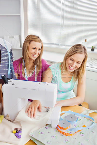 Animated female friends sewing clothes together at home in the kitchen Stock photo © wavebreak_media