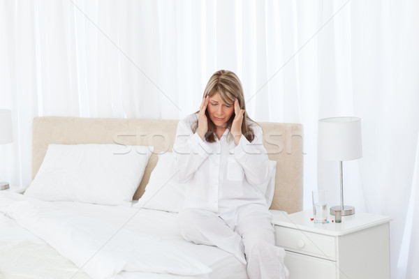 Woman having a headache on her bed Stock photo © wavebreak_media