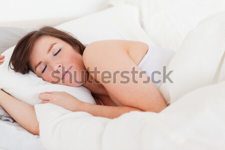 Attractive brunette female having a rest while lying on a bed Stock photo © wavebreak_media