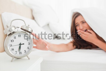 Displeased cute woman waking up in her bedroom Stock photo © wavebreak_media