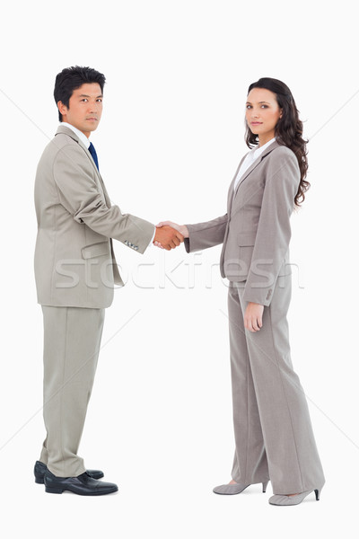 Side view of businesspeople shaking hands against a white background Stock photo © wavebreak_media