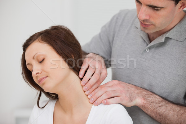Man massaging the neck of his patient in a medical room Stock photo © wavebreak_media