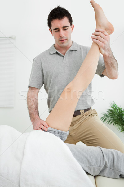 Physiotherapist raising the leg of a patient in a room Stock photo © wavebreak_media