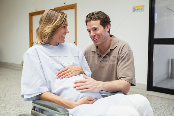 Pregnant woman in wheelchair talking with partner in hospital corridor Stock photo © wavebreak_media